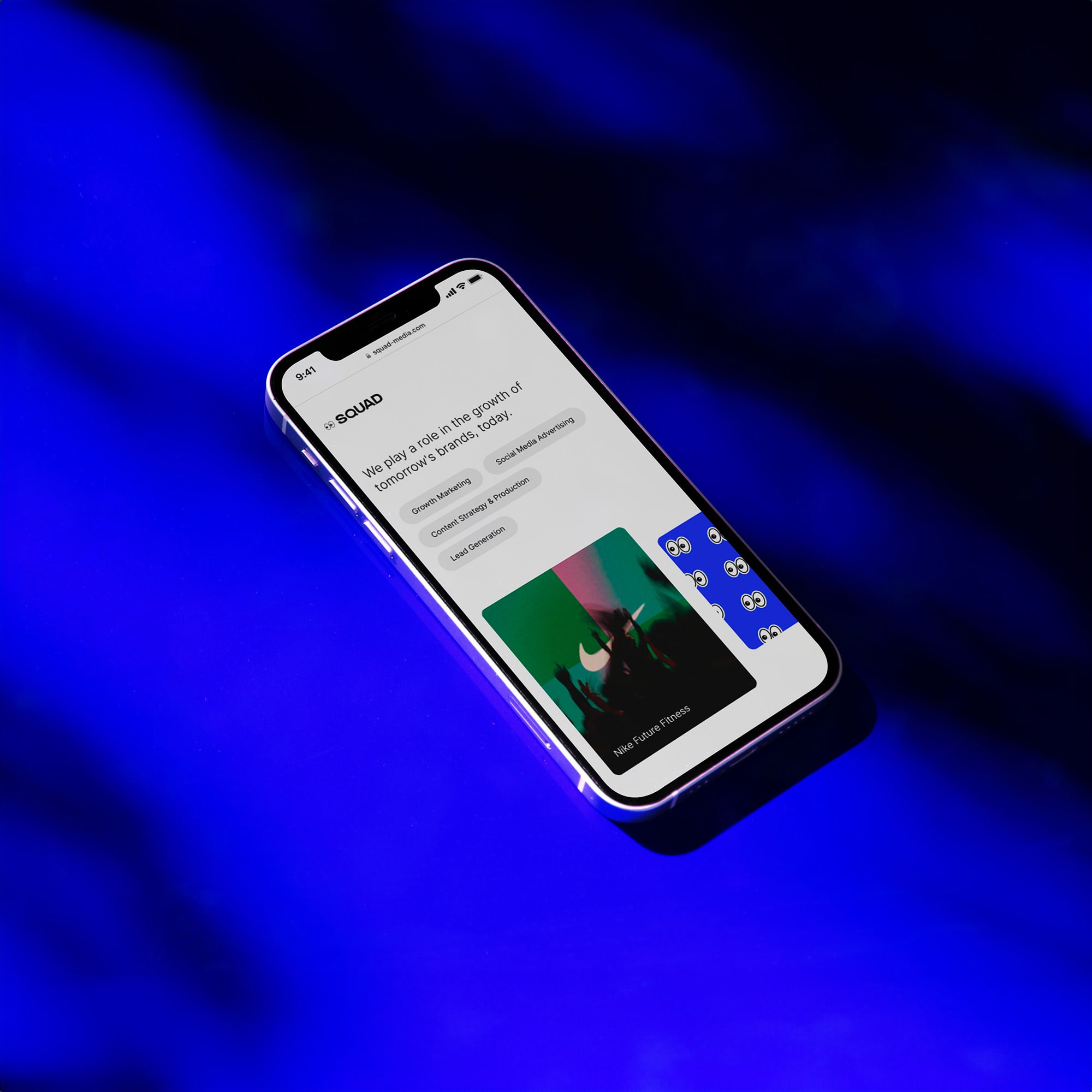 iPhone mockup of Squad's website on a blue floor