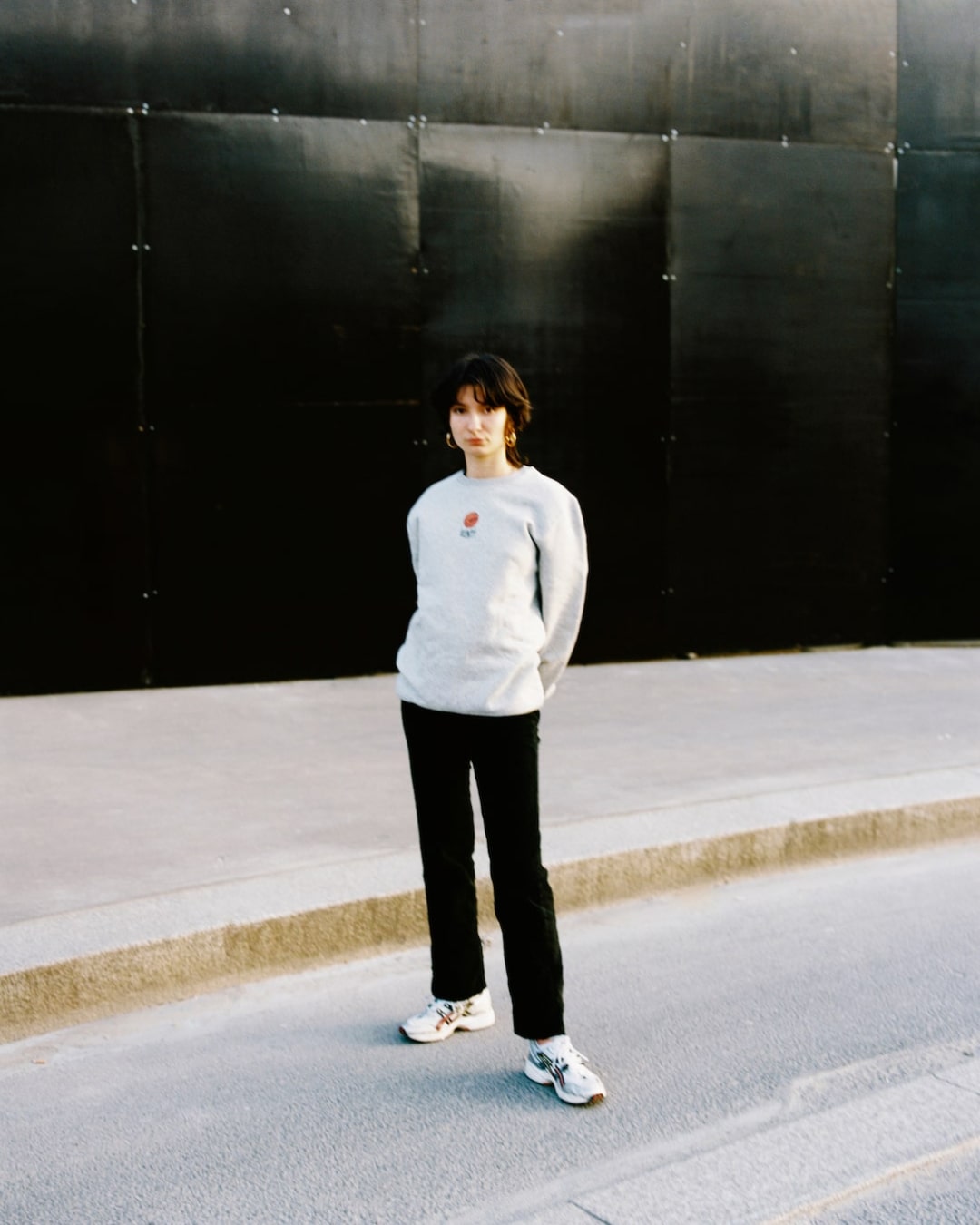A woman wearing a grey crewneck from the Fall Winter 2020 Huntt collection