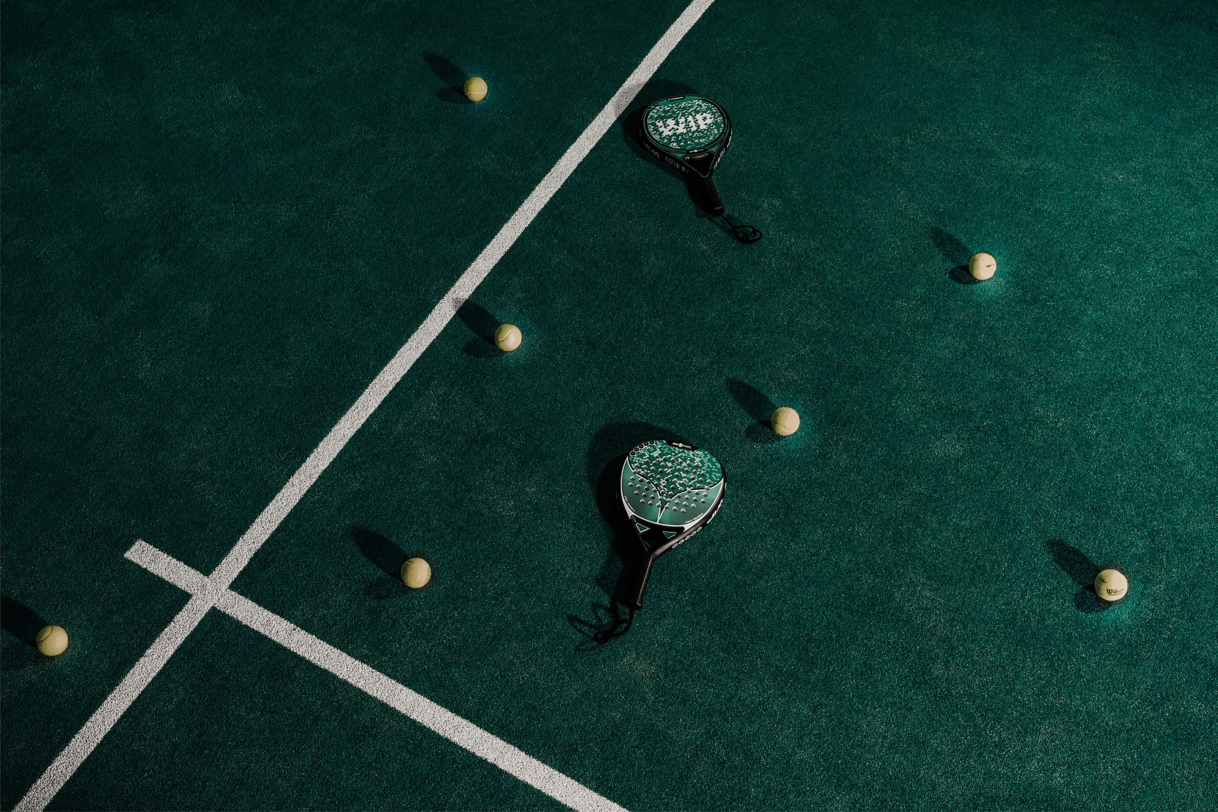 Padel rackets and padel ball on a tennis field